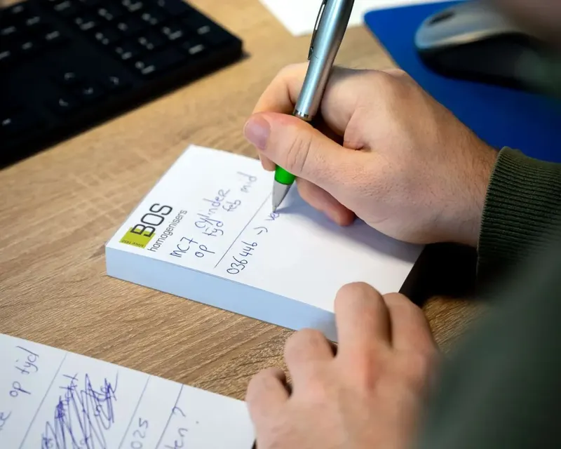 Taking notes during a customer call at BOS